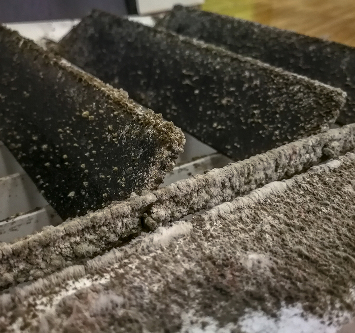 Technician cleaning residential air ducts